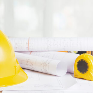 Work safety. Standard Construction site protective equipment on table wooden background, flat lay, copy space,safety first concepts.
